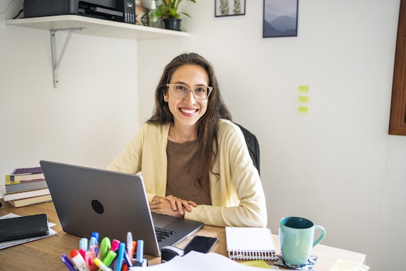 Nutritionist smiling in front of laptop